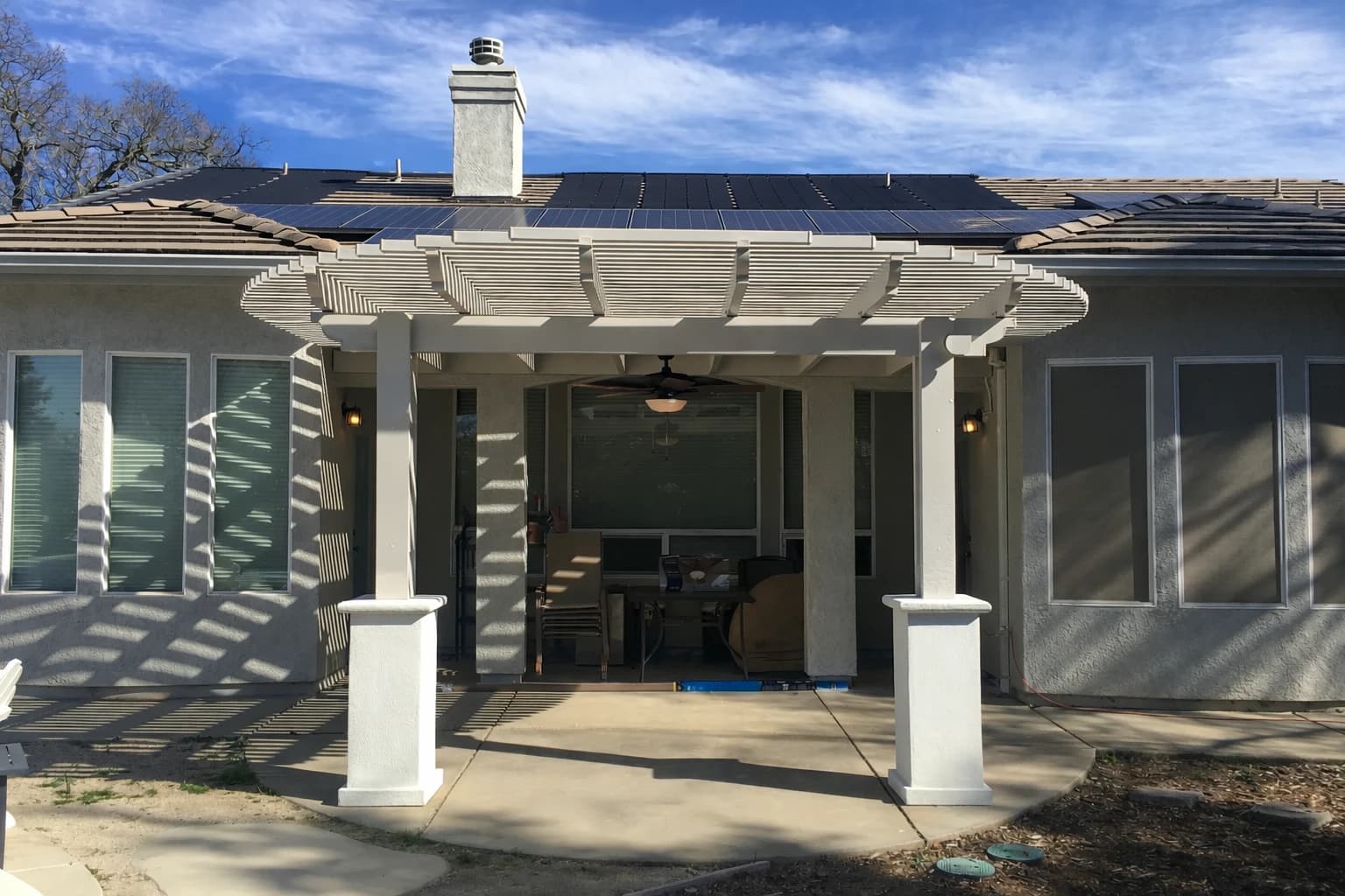 Lattice patio cover installation in a Natoma Station style backyard