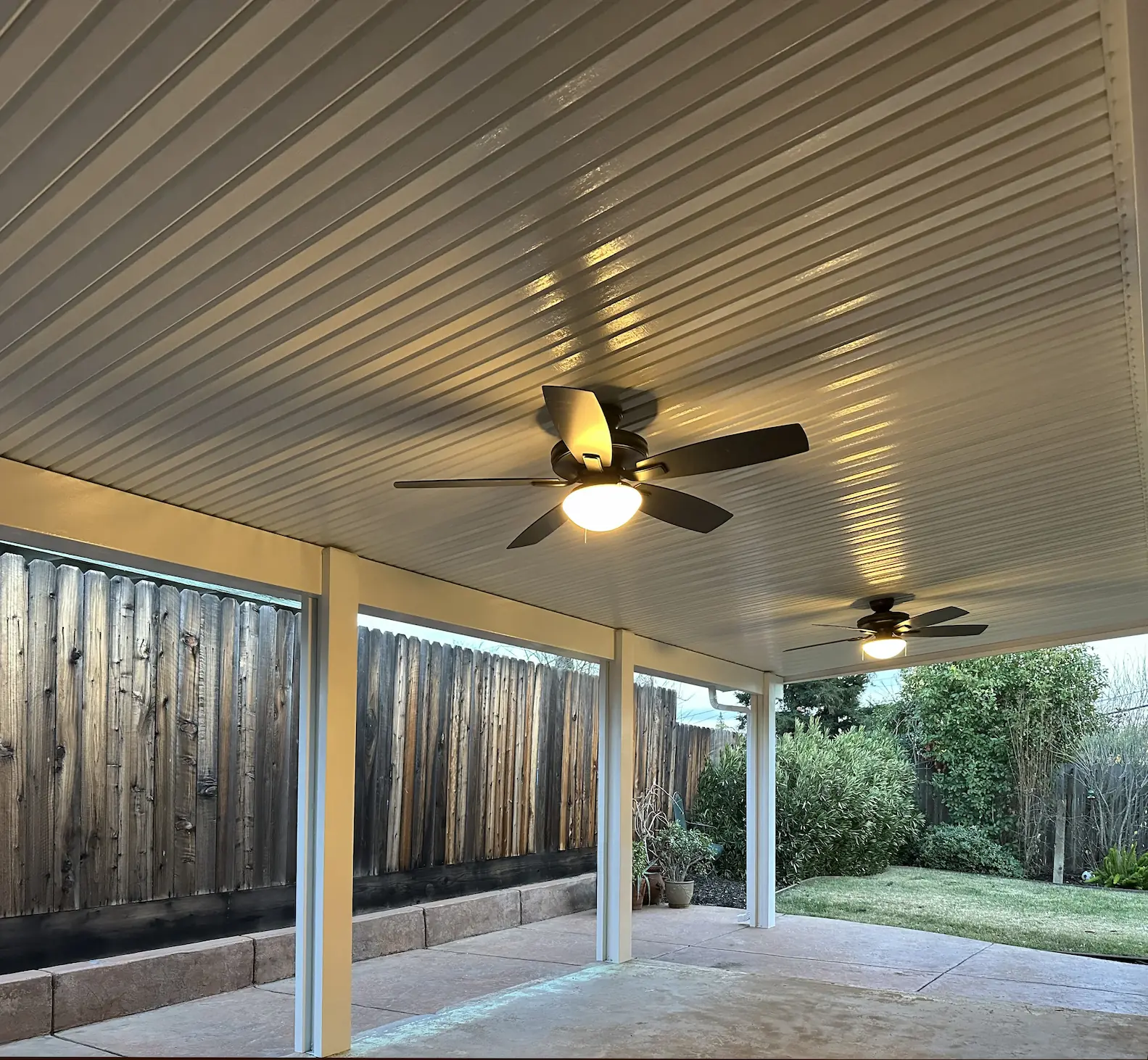 White attached solid patio cover on a modern Sacramento-area home by DCI Patios